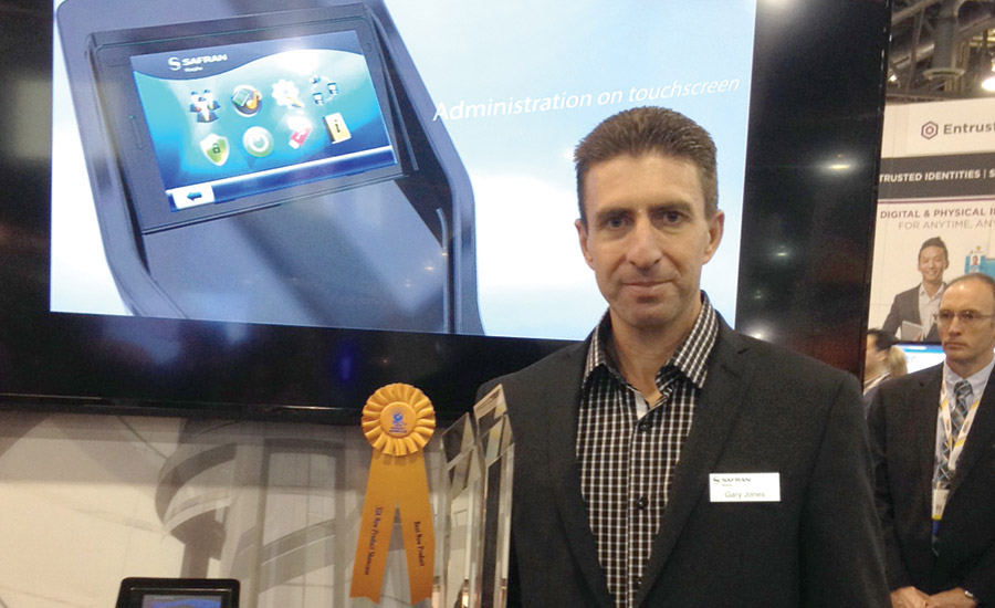 Safran Morpho's Gary Jones poses with the trophy his company won for Best New Product in the New Product Showcase Awards Program at ISC West.