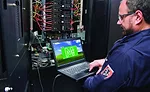 schneider guy in data center looking at monitor