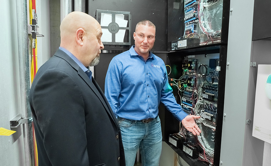 Luigi Martiniello and Josh Scholl in front of one of the iStar Ultra panels