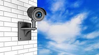 Video Camera Security System over Brick Wall with a sky background