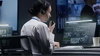 woman in front of security monitor