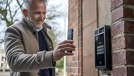 Man using cellphone to access building