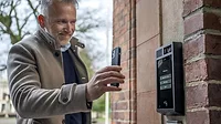 Man using cellphone to access building