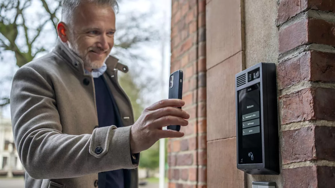 Man using cellphone to access building