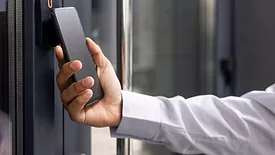 Man using cellphone to access building