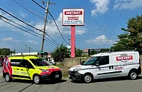 Image of American Alarm and Instant Alarm vans.