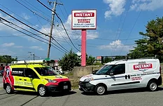 Image of American Alarm and Instant Alarm vans.