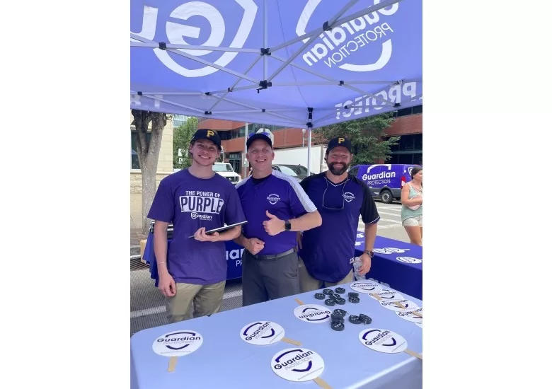 image of guardian protection vice president distributing swag to gamegoers