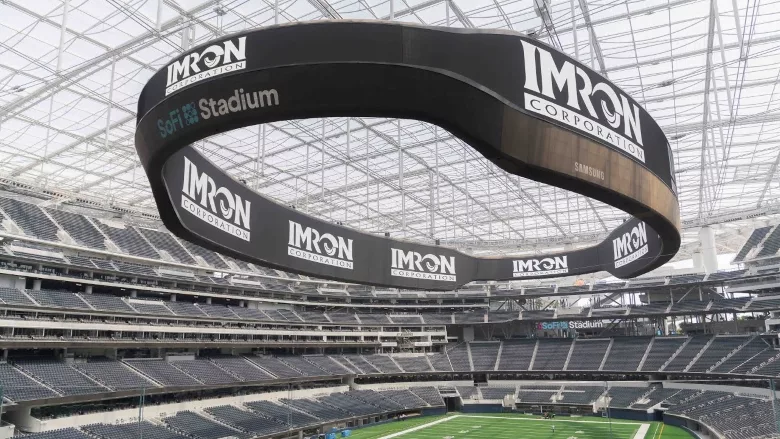 Image of IMRON on a Jumbotron at a stadium.