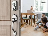 image of electronic lock in foreground with family sitting inside the home in the background