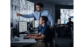 Two Monitoring Employees Looking at a Screen