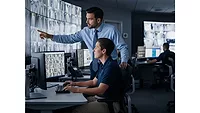 Two Monitoring Employees Looking at a Screen