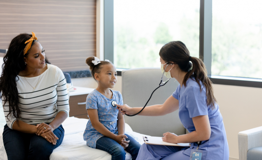 Doctor examining child patient with mother present in medical clinic