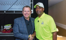 NFL Hall of Fame Member and 2015 Pro-Bowl Co-Captain Chris Carter shakes hands with AiN Group president Stan Matysiak.