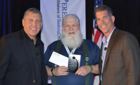 Perennial Software employee Matt Howe (center), with Perennial Software cofounders Michael Marks (left) and Don Faybrick (right), win Give Back Award.